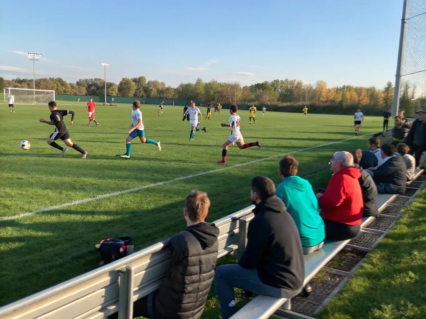 An inspiring image of adults participating in a soccer match, showcasing the camaraderie and competitive spirit of the adult sports program.